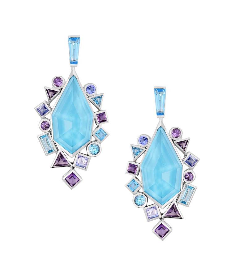 Stephen Webster earrings from the new Gold Struck collection, featuring a central sky-blue facetted crystal with bezel-set blue and mauve stones.